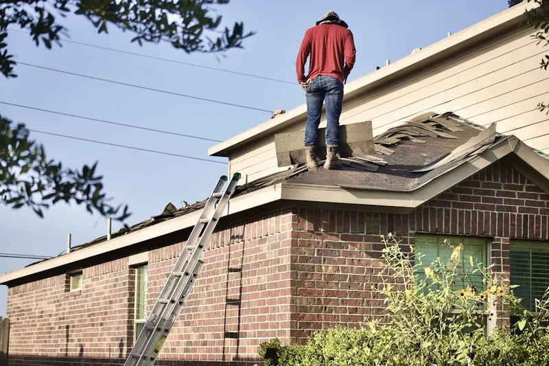 Professional roofer working on a residential roof in Disston Heights